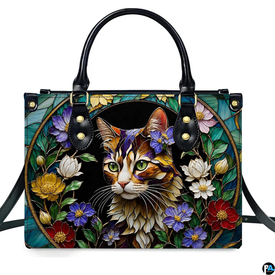 Front studio shot of stained glass cat portrait and floral medallion.