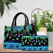 Neon eyeball handbag and wallet displayed on wooden table beside potted plant.