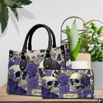 Violet skull handbag and matching wallet displayed on wooden table beside potted plant.