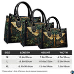 Bottom view of gold dragonfly handbag showing protective metal feet studs and smooth base wrap