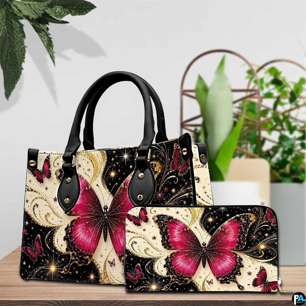 Lifestyle tabletop view showing magenta butterfly artwork placed beside decorative indoor house plants.
