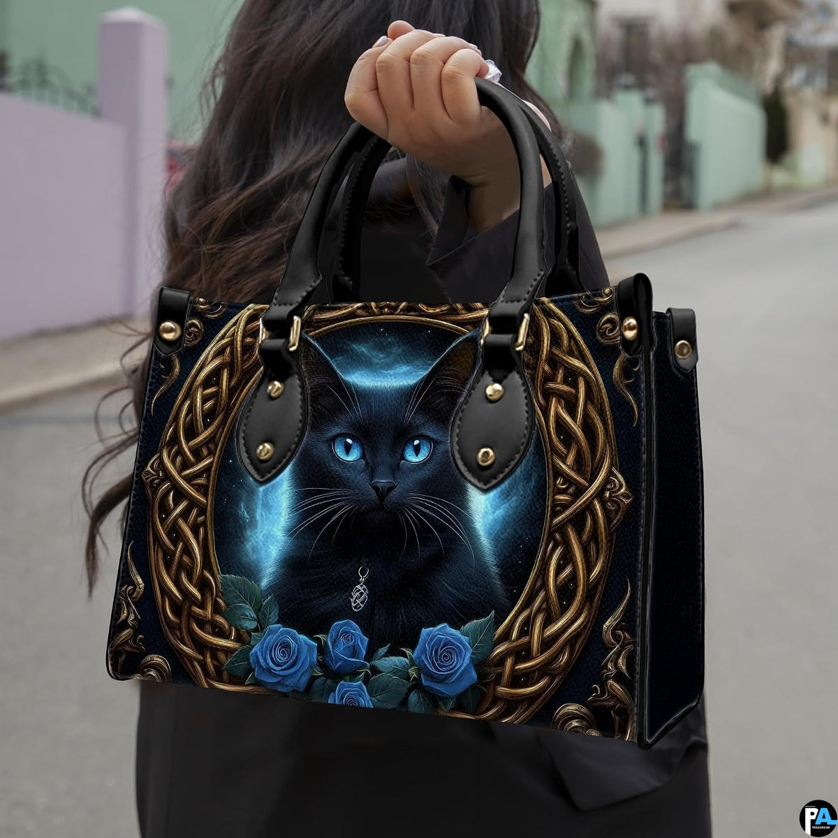 Outdoor perspective showing Celtic black cat artwork held over arm by pedestrian along city sidewalk.