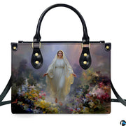 Front isolated view of Virgin Mary meadow handbag detailing radiant gown and wildflowers.