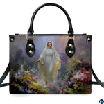 Front isolated view of Virgin Mary meadow handbag detailing radiant gown and wildflowers.