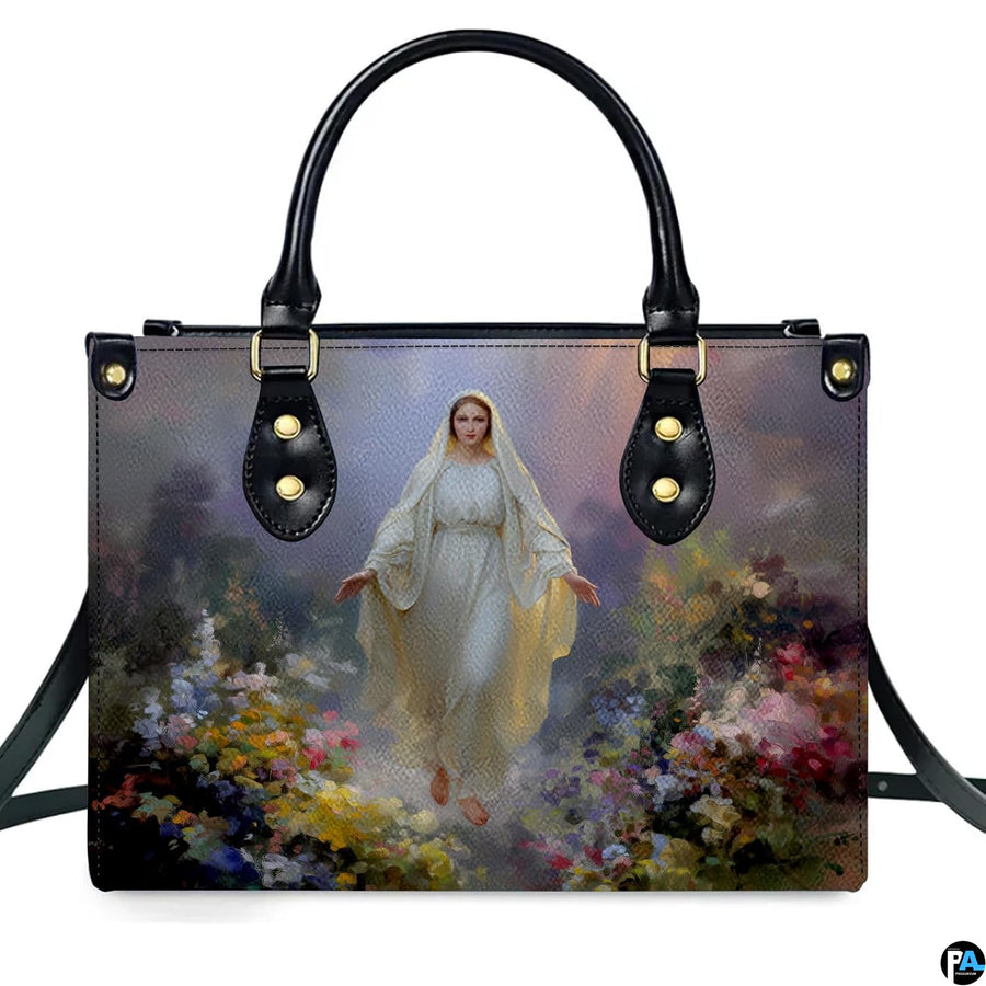 Front isolated view of Virgin Mary meadow handbag detailing radiant gown and wildflowers.