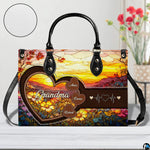 Frontal presentation of stained glass sunrise floral motif positioned on light wooden surface.