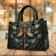 Side profile of dragonfly key handbag showing clean seams and dark botanical pattern