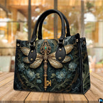 Side profile of dragonfly key handbag showing clean seams and dark botanical pattern