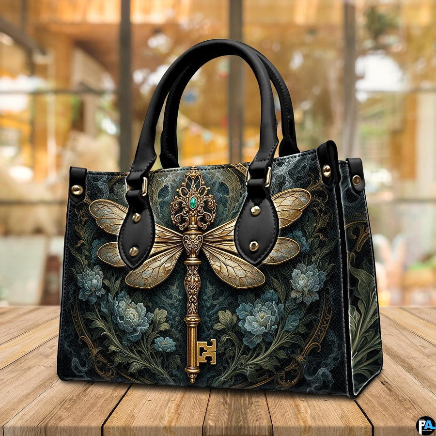 Side profile of dragonfly key handbag showing clean seams and dark botanical pattern