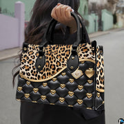 Flat display of animal print and quilted heart handbag paired with companion zip wallet.