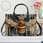 Side profile view of the bee handbag displaying structured silhouette and black carrying handles.