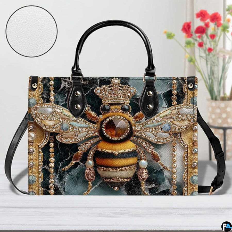 Side profile view of the bee handbag displaying structured silhouette and black carrying handles.
