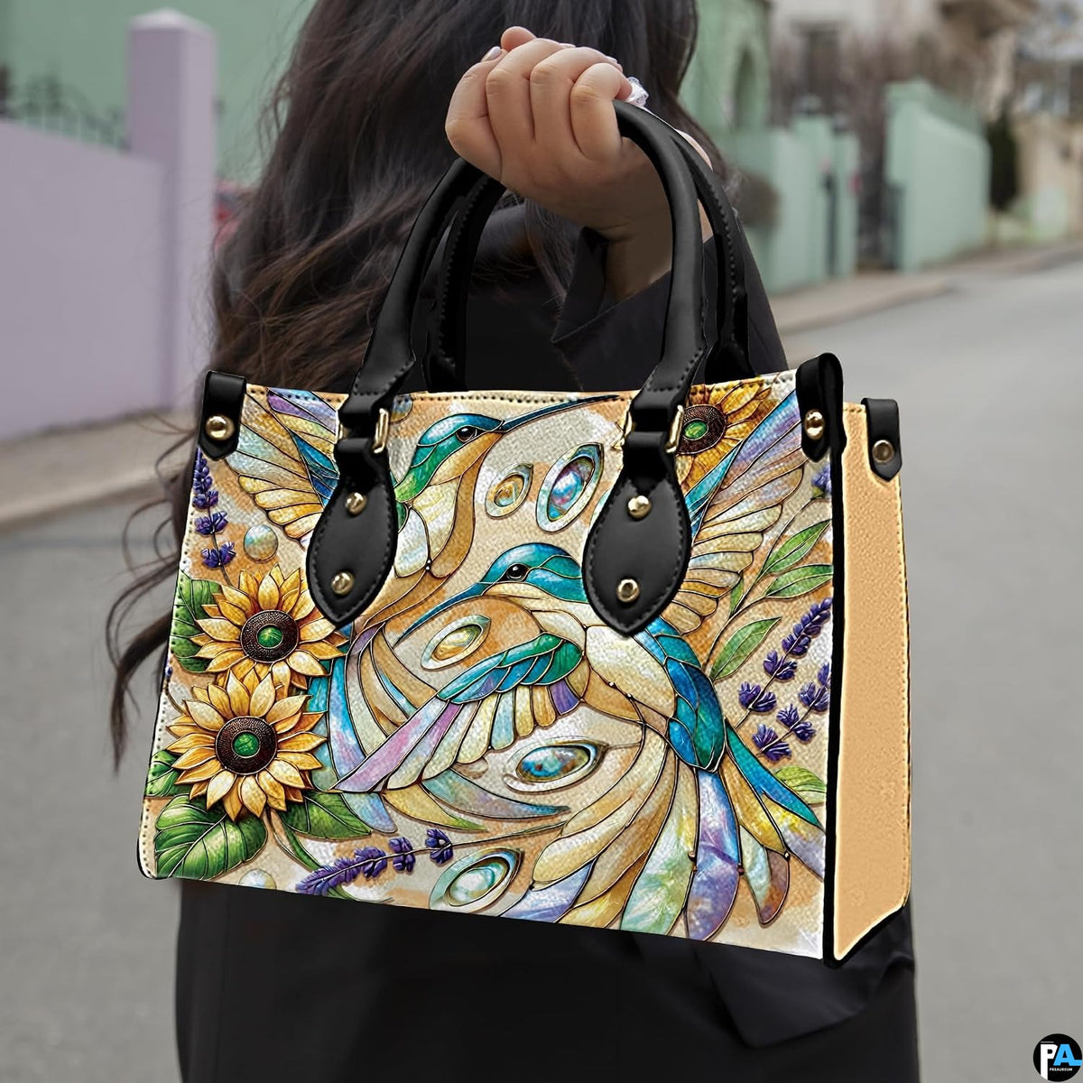 Detailed view of mosaic floral petals and turquoise bird artwork across handbag.