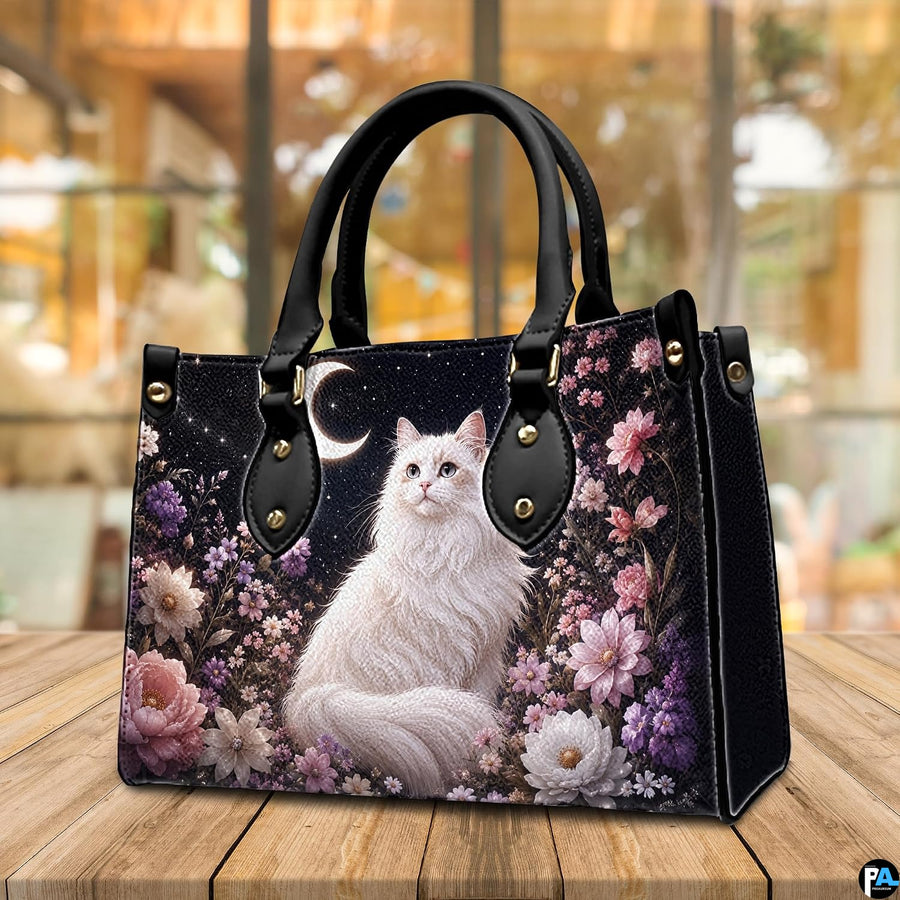 Cafe setting presenting celestial white cat artwork resting on a wooden tabletop near windows.