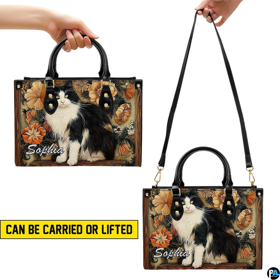 Carrying presentation showing handheld and shoulder display methods for black white cat art botanical design.
