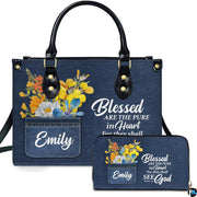Front view of scripture denim wildflower handbag and matching zip wallet on solid white background