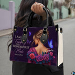 Outdoor lifestyle presentation showcasing the purple devotional portrait handbag held by a model.