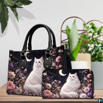 Indoor scene presenting celestial white cat artwork and companion accessory beside potted plants.