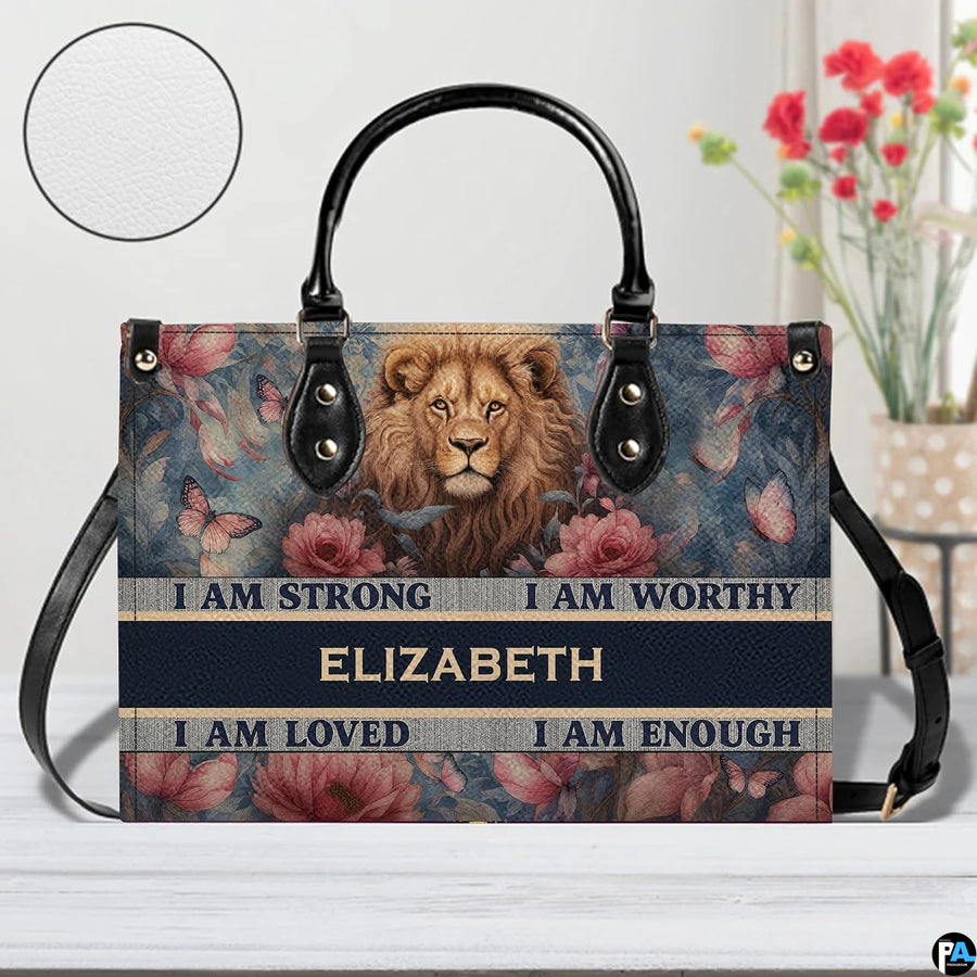 Front view of lion floral handbag on white tabletop with circular textured exterior swatch.