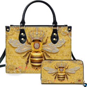 Golden honeycomb bee handbag and matching zip wallet displayed against studio background with crown details.