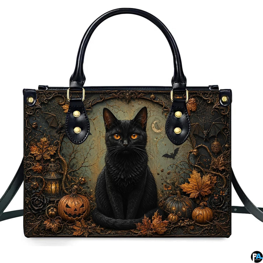 Front studio shot of black cat, glowing jack-o-lanterns, autumn leaves, and vintage lantern.