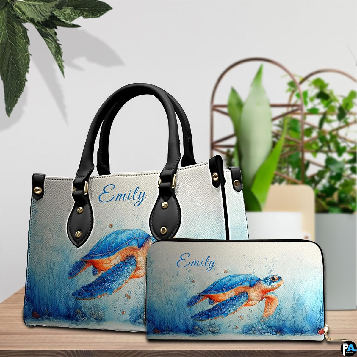 Lifestyle model display showing the watercolor turtle handbag carried over the shoulder.
