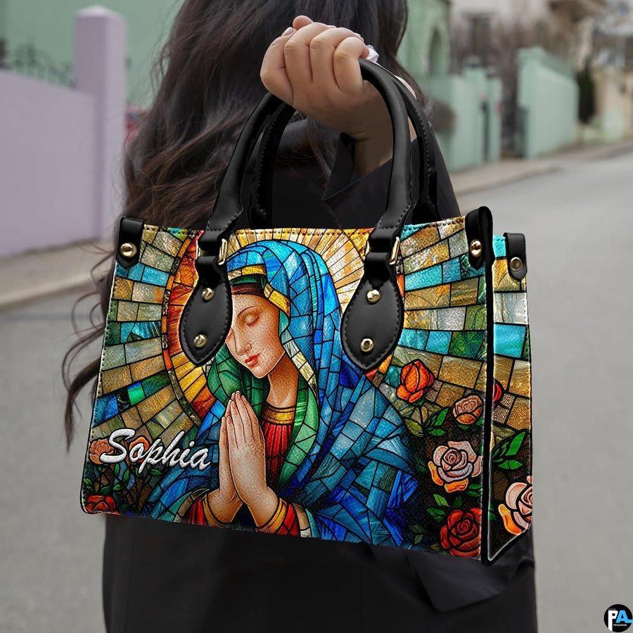 Outdoor lifestyle photo of model holding sacred stained glass design accessory along quiet street.