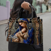 Outdoor street view of person holding sacred mother and child themed accessory.