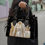 Angled view of black doctor handbag highlighting golden medical tools and coat graphic