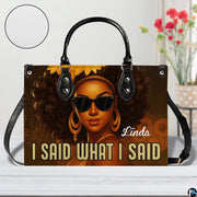 Handbag presented on light tabletop with floral decor and surface texture highlight.