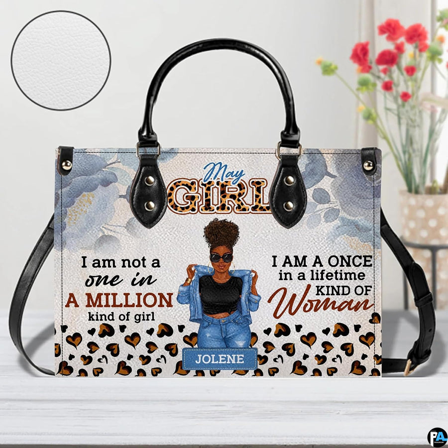 Front view of afro puff art accessory highlighting illustrated portrait, watercolor florals, and leopard heart spots.