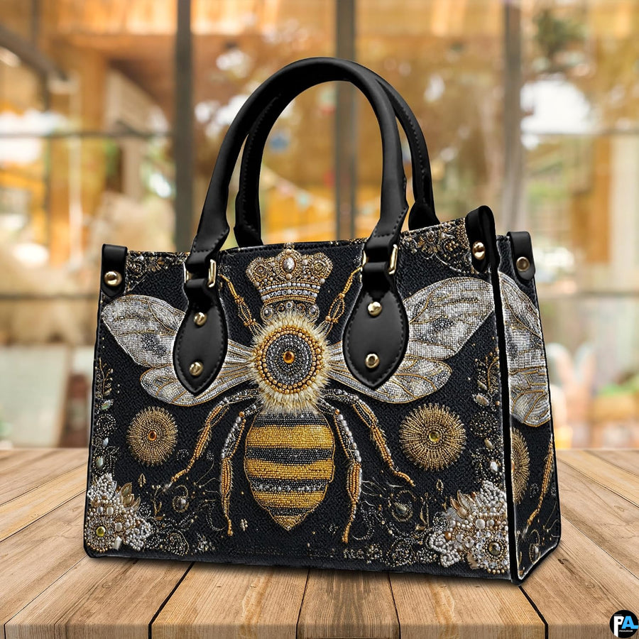 Top down view of bee handbag showing zipper closure and interior opening.