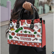 Handbag held outdoors showing colorful Christmas graphics and playful typography in natural light.