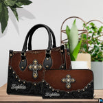 Detailed view of ornate filigree cross centerpiece and textured chestnut background on handbag.