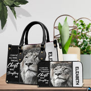 Devotional crowned lion handbag and matching wallet displayed beside decorative greenery.