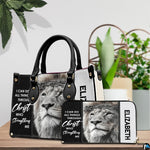 Devotional crowned lion handbag and matching wallet displayed beside decorative greenery.