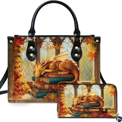 Autumn sleeping dragon on antique books artwork displayed across top-handle handbag and matching companion wallet.