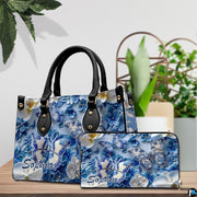 Close-up front view of handbag showing cobalt butterfly and hydrangeas