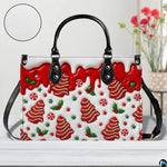 Front perspective of holiday handbag with confectionery gingerbread print alongside close-up texture detail.