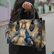 Outdoor lifestyle photo of model carrying crowned Virgin Mary handbag on street