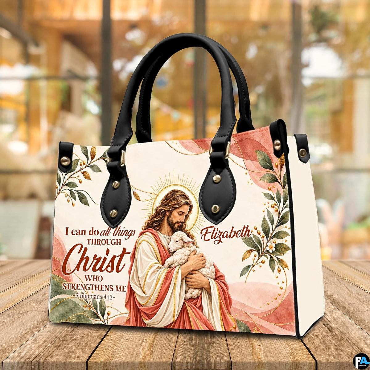 Good Shepherd handbag displayed on wooden tabletop in front of sunlit cafe window.