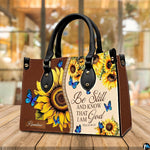 Top view showing carrying handles and main zippered opening of sunflower floral purse.