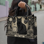 Model walking outdoors holding the black cat tarot card art printed creation.