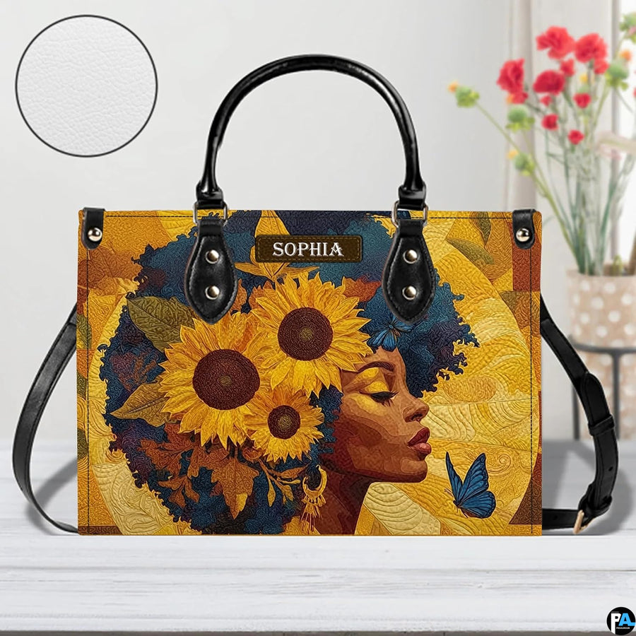 Frontal viewpoint of the sunflower afro artwork on a studio surface beside fresh red floral blossoms.