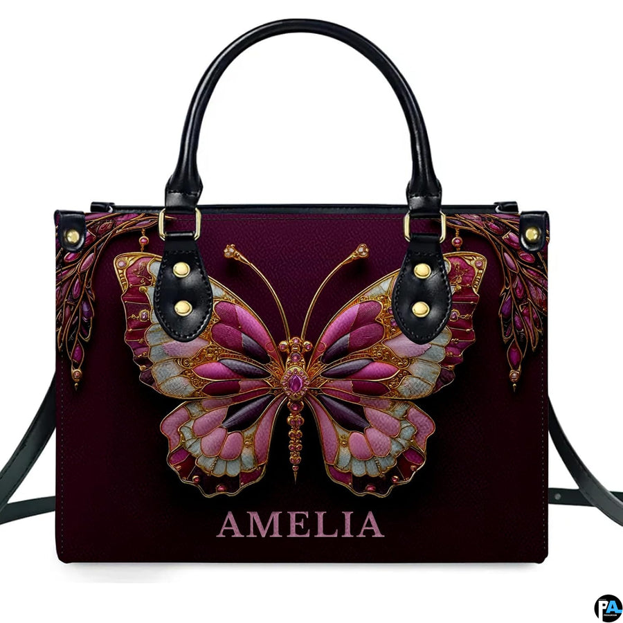 Model carrying jeweled butterfly handbag and matching wallet demonstrating scale
