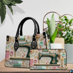 Antique sewing machine art resting beside indoor decorative flora on a wooden surface.