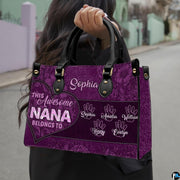 Front view of purple handbag featuring contoured heart outline and rich floral lace patterns.