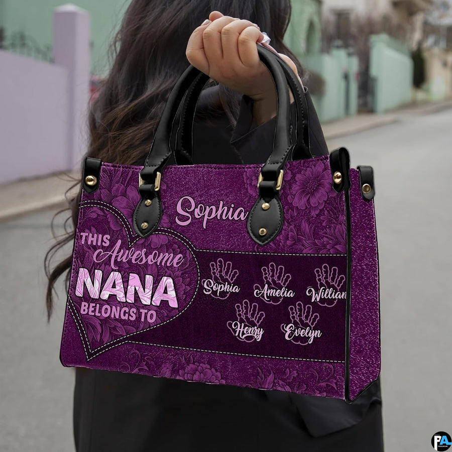 Front view of purple handbag featuring contoured heart outline and rich floral lace patterns.