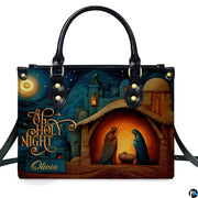 Close-up front view of holy family at the manger inside illuminated stable on structured tote handbag