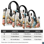 White floral devotional handbag displayed on wooden plank tabletop with warm background bokeh.
